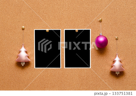 Empty photos and Christmas tree toys are pinned on a cork board. Copy space 133751381