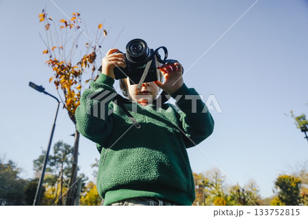 Child Learning Photography with Camera in Nature 133752815
