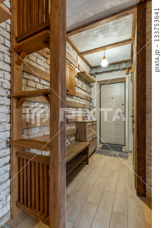 Rustic Wooden Hallway with Brick Wall and Warm Lighting Rustic Wooden Hallway with Brick Wall and Warm Lighting 133753641