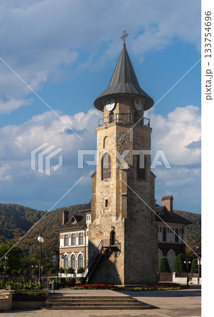 Medieval stone clock tower stands tall under clear Piatra Neamt sky 133754696