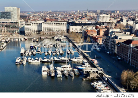 Antwerp city waterfront marina aerial view, boats moored along the docks, historic architecture in background Antwerp city waterfront marina aerial view, boats moored along the docks, historic architecture in background 133755279