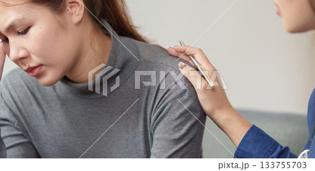 Mental Health Support. A compassionate therapist comforting a distressed woman during a session. 133755703