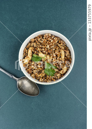 Cooked buckwheat porridge with meat stew. Cooked buckwheat porridge with meat stew. 133755979