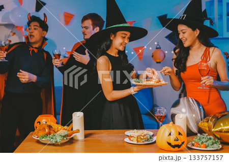 Joyful office Halloween party with coworkers in costumes, celebrating with drinks and laughter, fostering teamwork and festive spirit 133757157