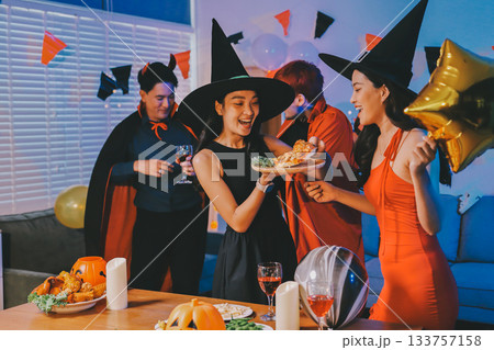 Joyful office Halloween party with coworkers in costumes, celebrating with drinks and laughter, fostering teamwork and festive spirit 133757158