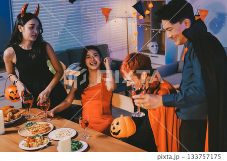 Joyful office Halloween party with coworkers in costumes, celebrating with drinks and laughter, fostering teamwork and festive spirit 133757175