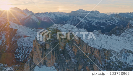 Panoramic view of Dolomite mountain peaks in beautiful morning light. Early winter scene with snow covered summits. 133758965