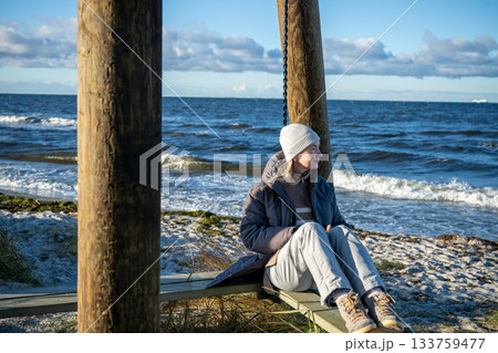 woman enjoying windy winter day on baltic sea coast woman enjoying windy winter day on baltic sea coast 133759477