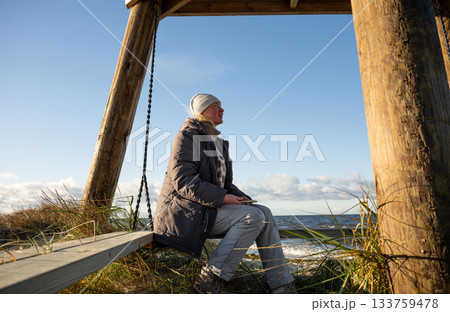 woman enjoying windy winter day on baltic sea coast woman enjoying windy winter day on baltic sea coast 133759478