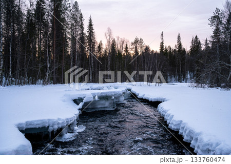 winter river flowing through snowy forest landscape in lapland winter river flowing through snowy forest landscape in lapland 133760474