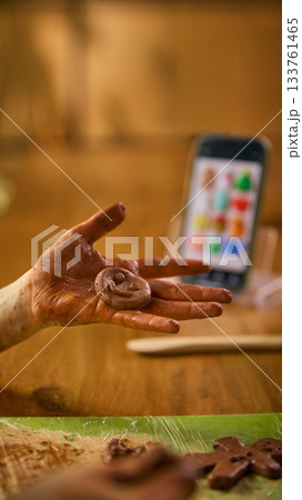 Child showing clay smiley figure in hand 133761465