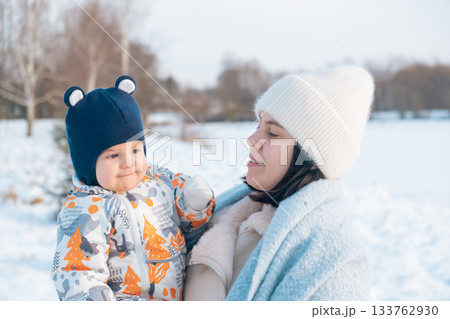 Mother and Baby Enjoying a Winter Day 133762930