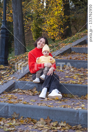 Mother and baby enjoying autumn outdoors 133762950