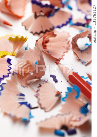 Colorful pencil shavings with drawing pencils and a sharpener on a white background Colorful pencil shavings with drawing pencils and a sharpener on a white background 133763127