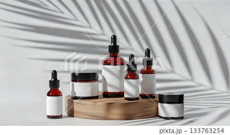 Minimalist cosmetic bottle mockup set on round wood slice with palm shadow amber glass skincare product packaging display with copy space 133763254