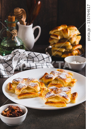 Sweet puff pastries with pineapple in powdered sugar on the table vertical view 133764617