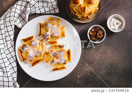 Sweet puff pastries with pineapple in powdered sugar on the table top view 133764619
