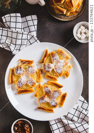 Mini baked pineapple tarts on a plate on the table top and vertical view Mini baked pineapple tarts on a plate on the table top and vertical view 133764621