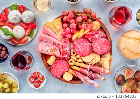 Italian Antipasti. Charcuterie tray with cheese and other appetizers, with wine Italian Antipasti. Charcuterie tray with cheese and other appetizers, with wine 133764835
