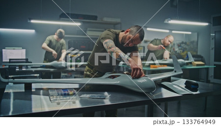 Concentrated Engineer Assembling Drone Internal Components 133764949