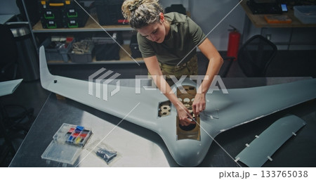 Organized Drone Factory Features Several Stations Where Engineers Assembling Large UAVs 133765038