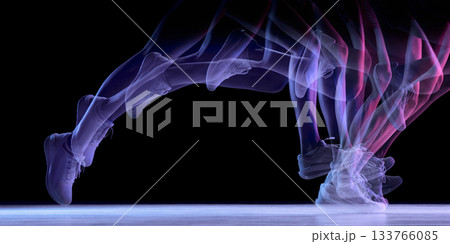 Dynamic motion-trail silhouette of running legs on dark background Dynamic motion-trail silhouette of running legs on dark background 133766085