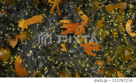 Golden Christmas Decorations on Festive Tree with Warm Lights 133767214