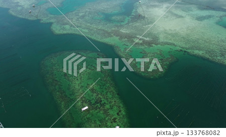 Coral reef and fish farm with cages for fish Coral reef and fish farm with cages for fish 133768082