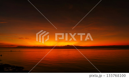 Stunning sunset over calm ocean waters Stunning sunset over calm ocean waters 133768100