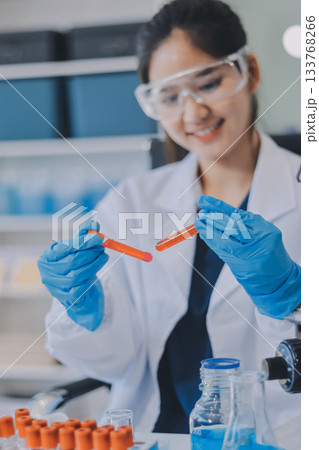 Portrait, science and happy woman on laptop in lab to research chemistry, test or innovation. Microscope, scientist and face of medical doctor in goggles for microbiology, healthcare or pharma study Portrait, science and happy woman on laptop in lab to research chemistry, test or innovation. Microscope, scientist and face of medical doctor in goggles for microbiology, healthcare or pharma study 133768266