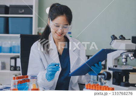 Portrait, science and happy woman on laptop in lab to research chemistry, test or innovation. Microscope, scientist and face of medical doctor in goggles for microbiology, healthcare or pharma study Portrait, science and happy woman on laptop in lab to research chemistry, test or innovation. Microscope, scientist and face of medical doctor in goggles for microbiology, healthcare or pharma study 133768276