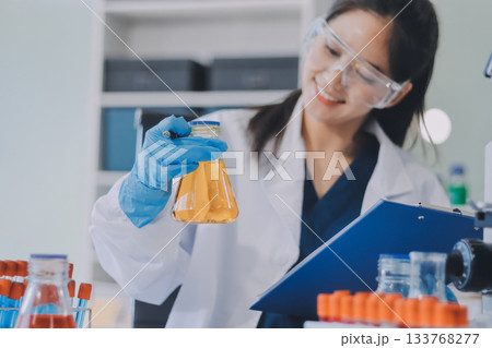 Portrait, science and happy woman on laptop in lab to research chemistry, test or innovation. Microscope, scientist and face of medical doctor in goggles for microbiology, healthcare or pharma study Portrait, science and happy woman on laptop in lab to research chemistry, test or innovation. Microscope, scientist and face of medical doctor in goggles for microbiology, healthcare or pharma study 133768277