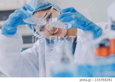 Portrait, science and happy woman on laptop in lab to research chemistry, test or innovation. Microscope, scientist and face of medical doctor in goggles for microbiology, healthcare or pharma study 133768291
