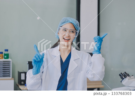 Portrait, science and happy woman on laptop in lab to research chemistry, test or innovation. Microscope, scientist and face of medical doctor in goggles for microbiology, healthcare or pharma study 133768303