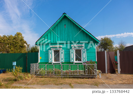 One-story Russian village house with carved shutters. 133768442