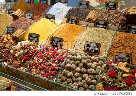 A vibrant display of spices and teas, offering a sensory feast of colors and aromas. The image captures a wide array of products. 133768555