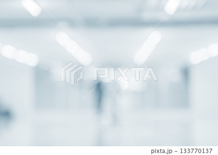 Blurred hospital hallway with bright clean lighting and soft blue tone background 133770137