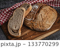 Whole grain sourdough bread with cut slices 133770299