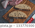 Sourdough bread slices on rustic wooden cutting board 133770300