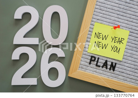 white number of New Year 2026 with word "plan" and post-it paper with text "new year new you" pin on letter board, symbolizing fresh goals, motivation, and starts new year personal fresh planning. white number of New Year 2026 with word "plan" and post-it paper with text "new year new you" pin on letter board, symbolizing fresh goals, motivation, and starts new year personal fresh planning. 133770764