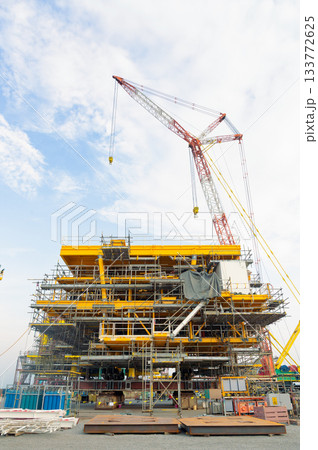 Offshore platform under construction with crane. 133772625