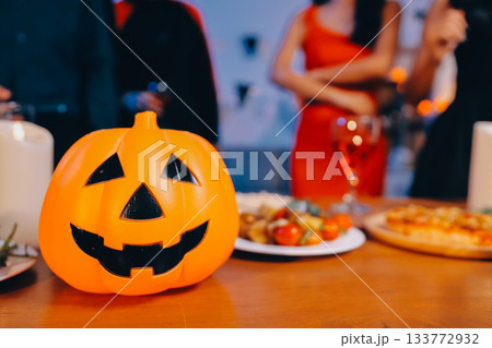 Joyful office Halloween party with coworkers in costumes, celebrating with drinks and laughter, fostering teamwork and festive spirit 133772932