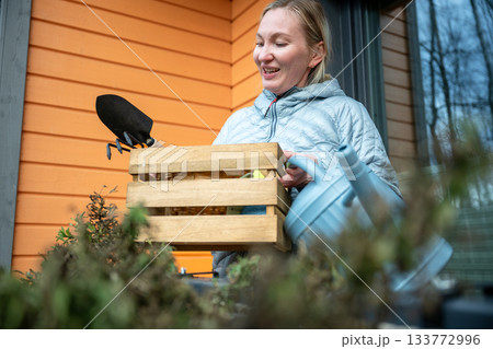 woman doing balcony gardening and cleaning tasks in autumn season woman doing balcony gardening and cleaning tasks in autumn season 133772996