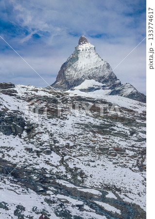 Scenic view on snowy Matterhorn mountain peak in sunny day with blue sky in Switzerland. Beautiful nature background of Swiss Alps covered with snow. Famous travel destination 133774617
