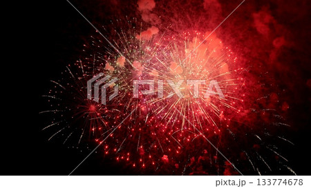 spectacular fireworks burst against dark night sky, dazzling array of colorful fireworks lighting up shadowed darkness, vivid and intense fireworks illuminate night with brilliant bursts of color 133774678