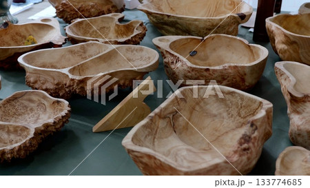 Wooden bowls display, Closeup of artistically crafted burl wood bowls with textured finish, Arrangement of meticulously crafted burl wood bowls emphasizing grain patterns and artisan 133774685