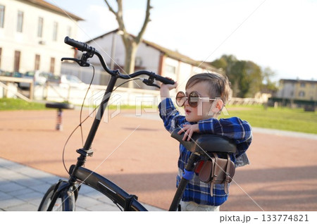 Child with Bicycle and Sunglasses in Park Child with Bicycle and Sunglasses in Park 133774821