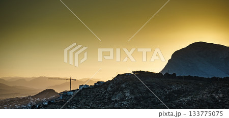 Construction site with crane. Spanish coast. Construction site with crane. Spanish coast. 133775075