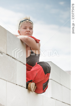 Woman taking break on construction site Woman taking break on construction site 133775478