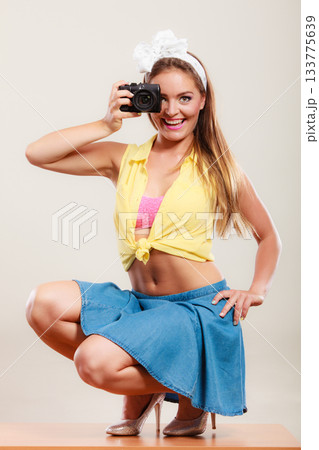 Pin up girl woman taking photo with camera. Pin up girl woman taking photo with camera. 133775639